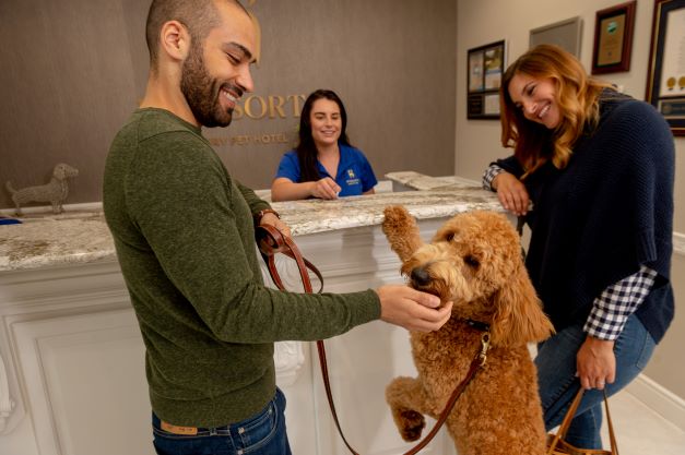 K9 customers with their dog at the front desk of a K9 Resort