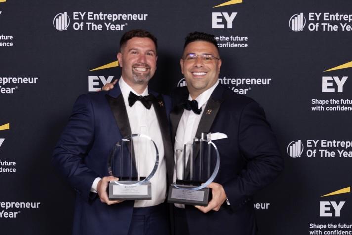 Two men winning an award